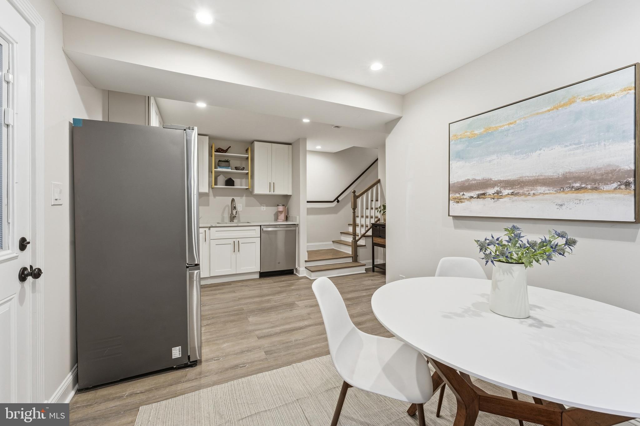 1524 Allison Street Northwest Washington, DC 20011 - Photo 46 of 85 a kitchen with stainless steel appliances a dining table chairs and a refrigerator