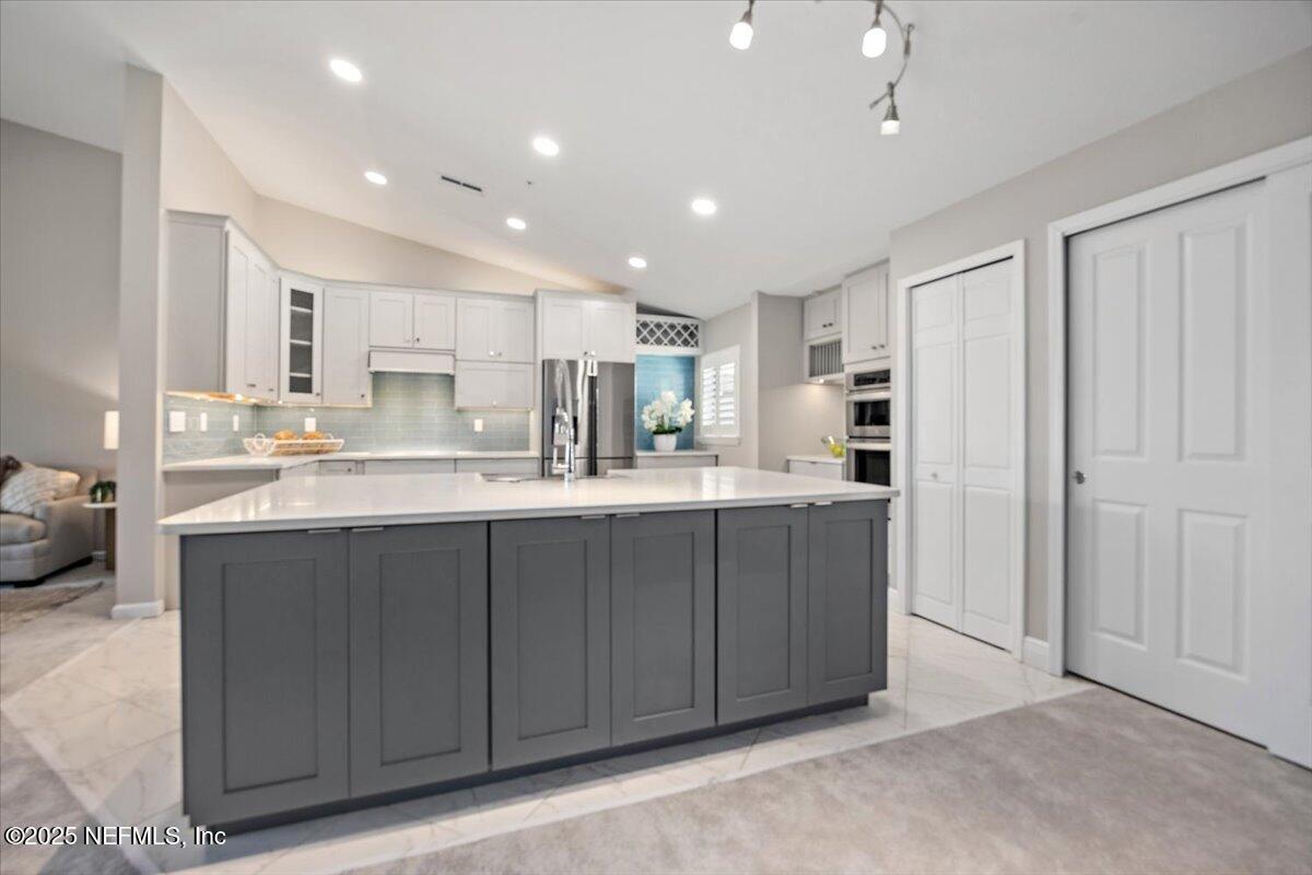 86 Fawn Gully Lane, Unit D Ponte Vedra, FL 32081 - Photo 13 of 29 a kitchen with stainless steel appliances granite countertop a refrigerator and a sink