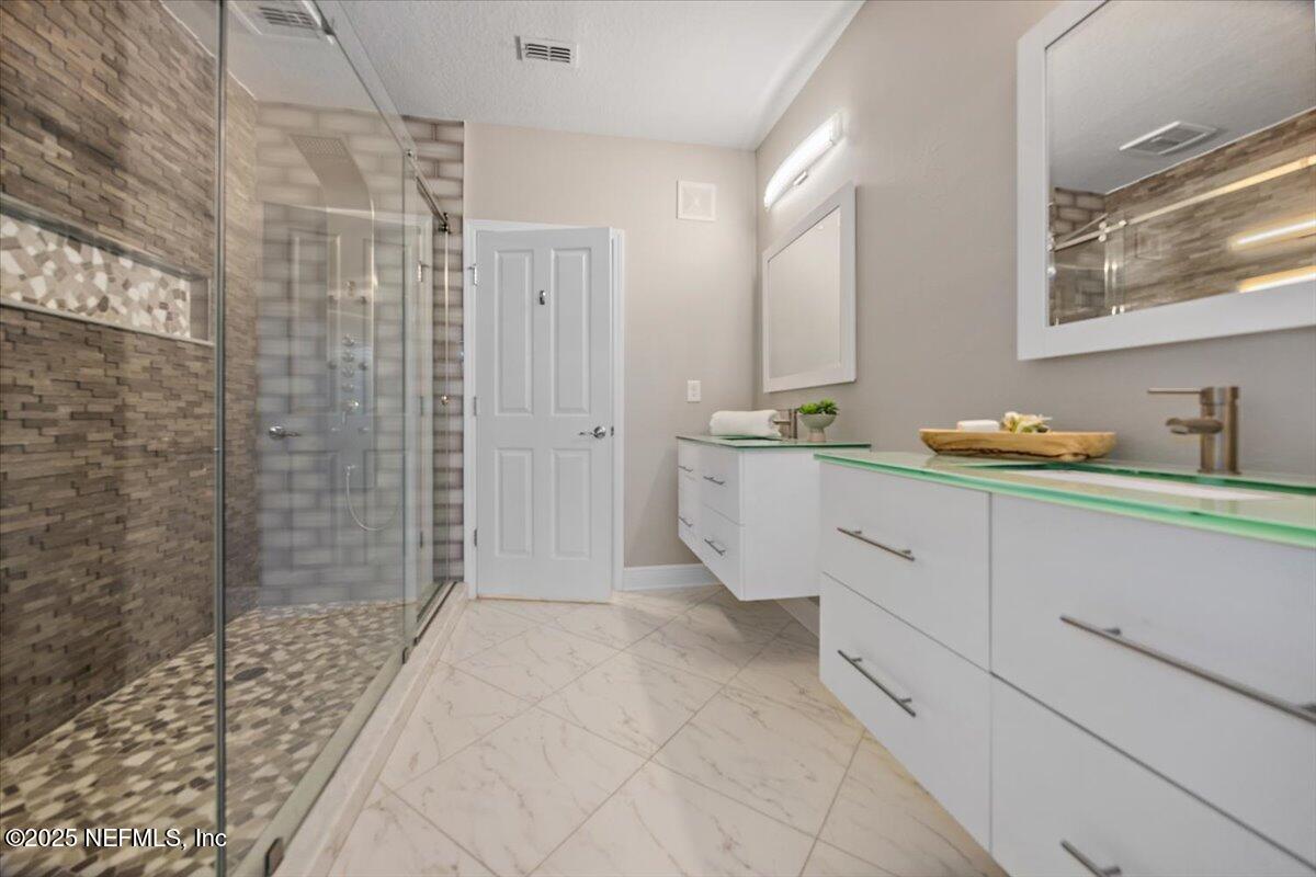 86 Fawn Gully Lane, Unit D Ponte Vedra, FL 32081 - Photo 17 of 29 a bathroom with a sink and a mirror