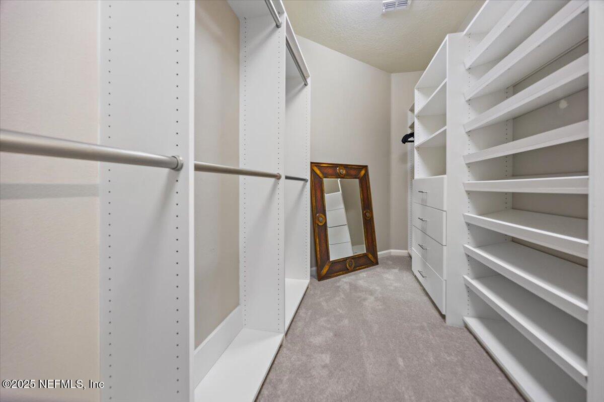 86 Fawn Gully Lane, Unit D Ponte Vedra, FL 32081 - Photo 18 of 29 a view of walk in closet with empty racks