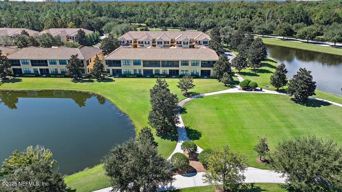 86 Fawn Gully Lane, Unit D Ponte Vedra, FL 32081 - Photo 2 of 29 an aerial view of a house with swimming pool patio and lake view