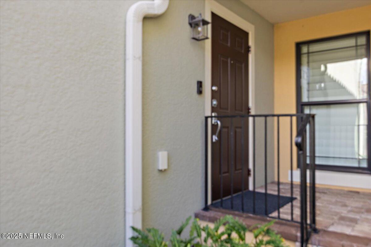 86 Fawn Gully Lane, Unit D Ponte Vedra, FL 32081 - Photo 5 of 29 a view of a hallway with wooden floor and glass door