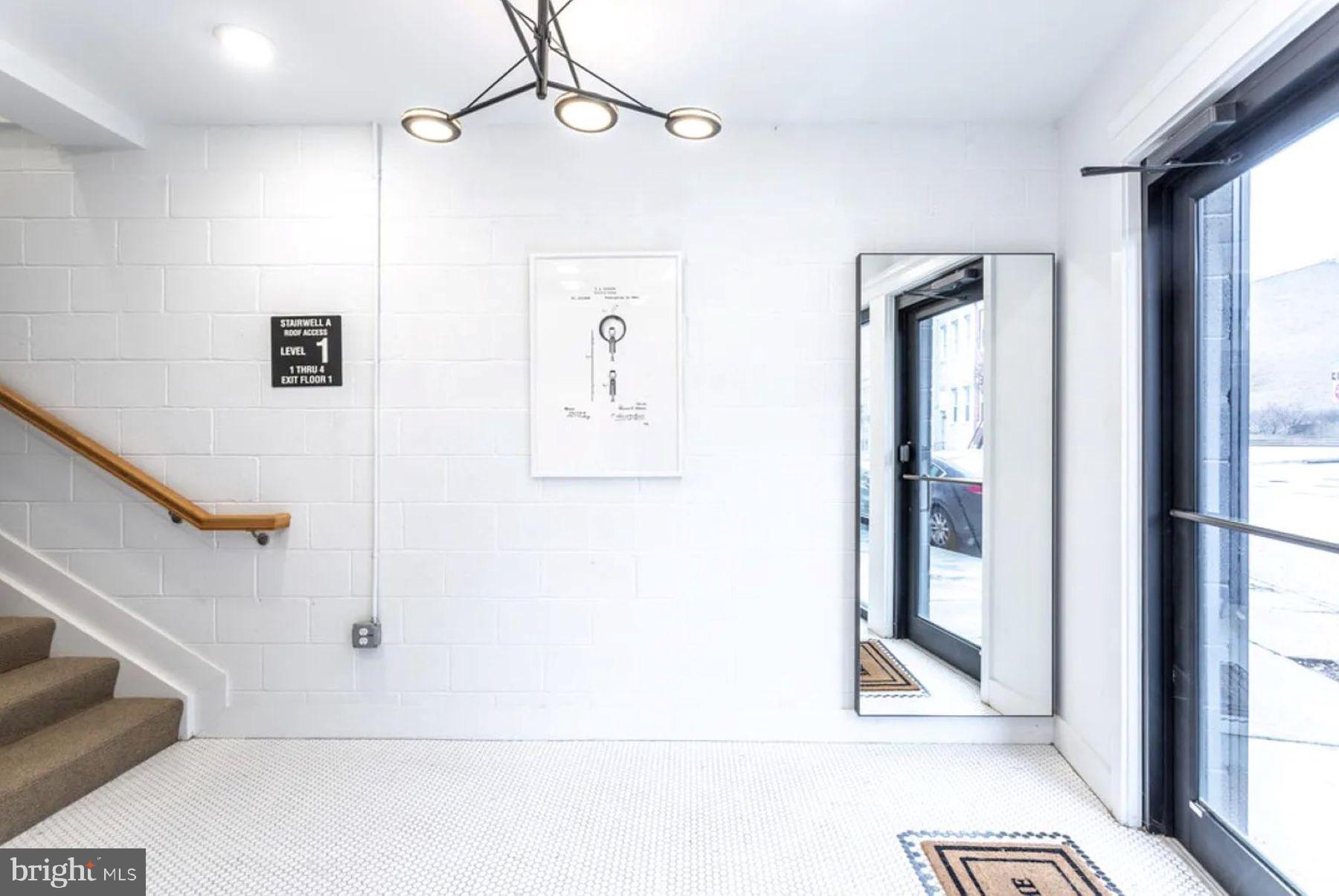1702 Light Street, Unit 203 Baltimore, MD 21230 - Photo 13 of 14 a view of a hallway with wooden floor and staircase
