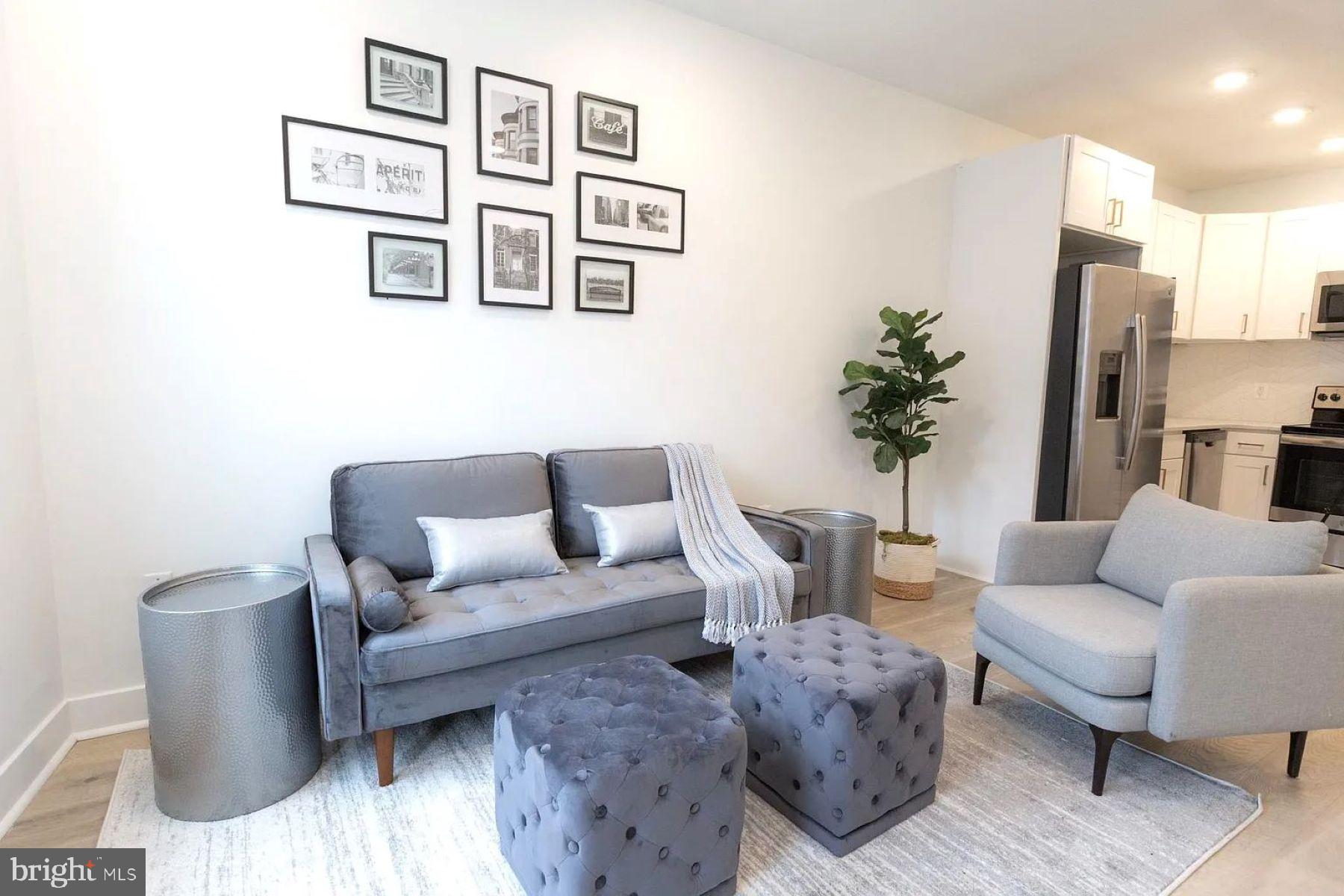 1702 Light Street, Unit 203 Baltimore, MD 21230 - Photo 3 of 14 a living room with furniture and painting on the wall