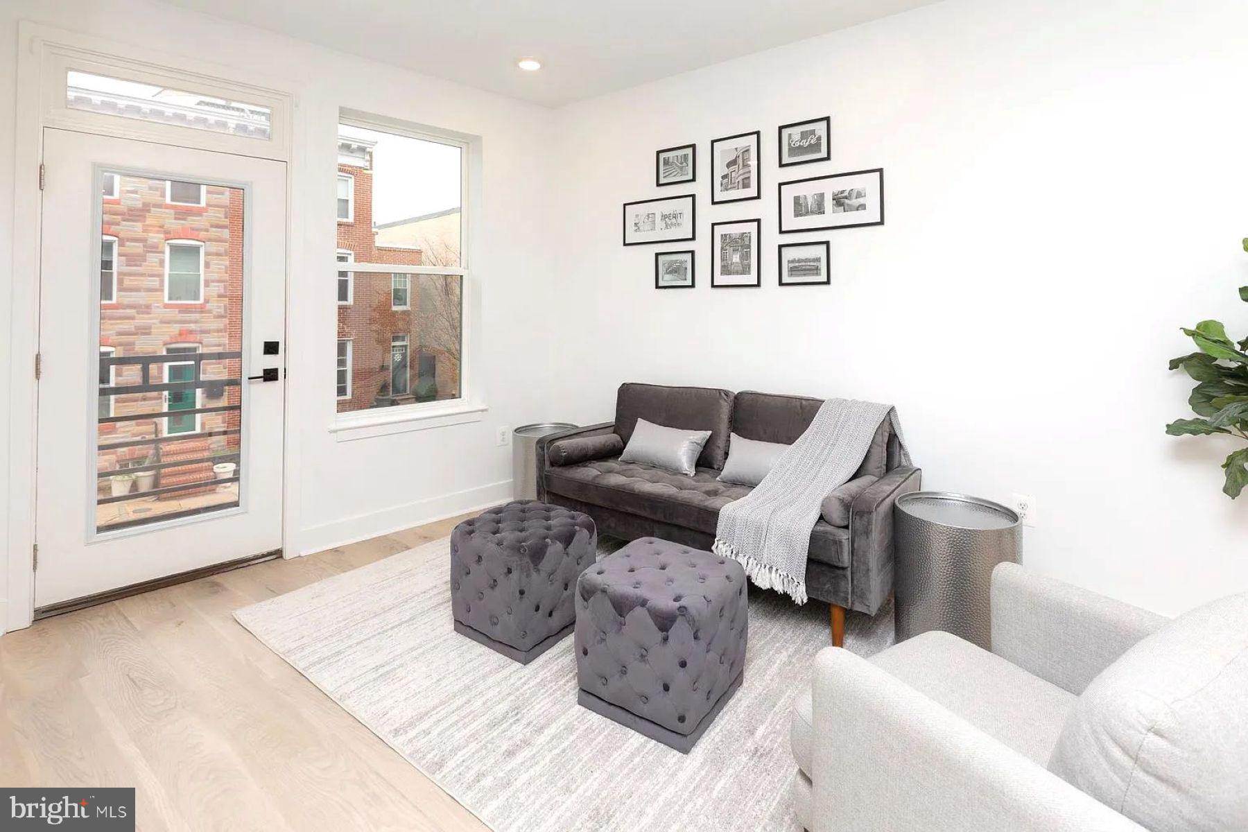 1702 Light Street, Unit 203 Baltimore, MD 21230 - Photo 4 of 14 a living room with furniture and large window