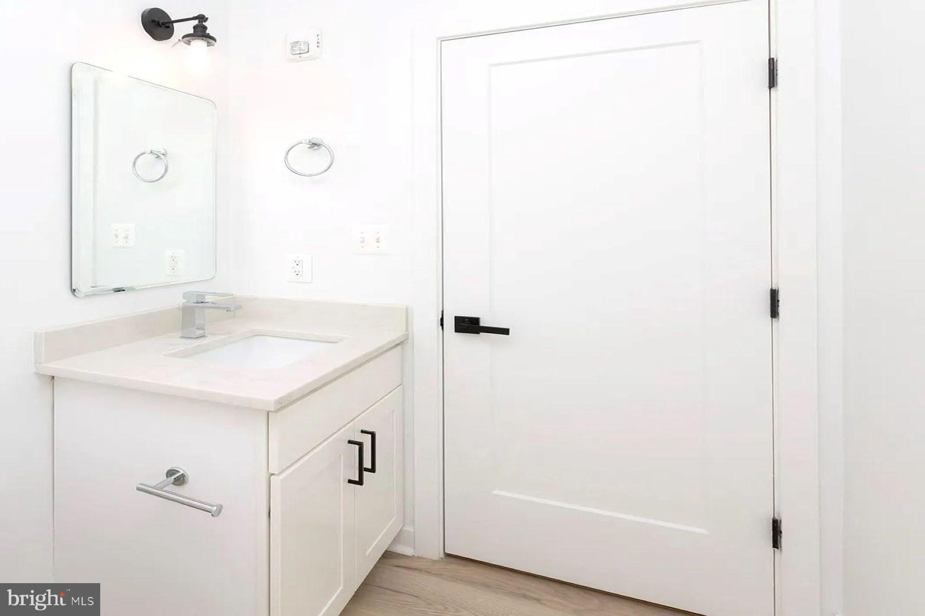 1702 Light Street, Unit 203 Baltimore, MD 21230 - Photo 7 of 14 a bathroom with a sink and a mirror