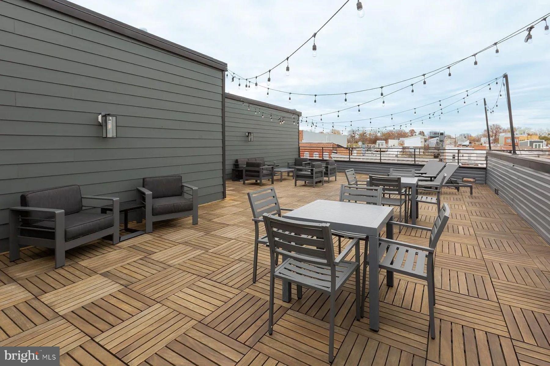 1702 Light Street, Unit 203 Baltimore, MD 21230 - Photo 8 of 14 a roof deck with a table and chairs