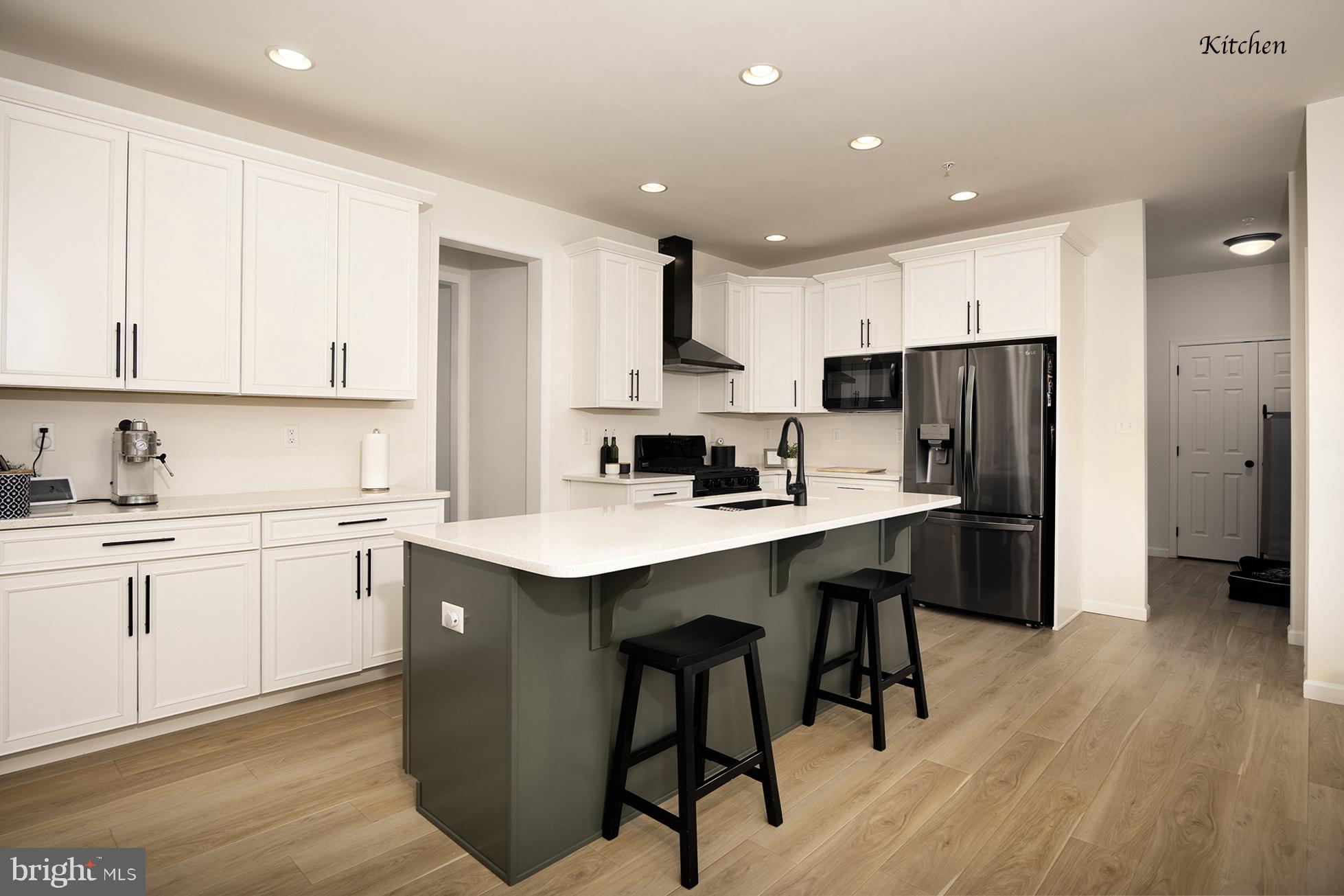 194 Cool Springs Road North East, MD 21901 - Photo 15 of 39 a kitchen with stainless steel appliances granite countertop a sink a stove a refrigerator and white cabinets with wooden floor