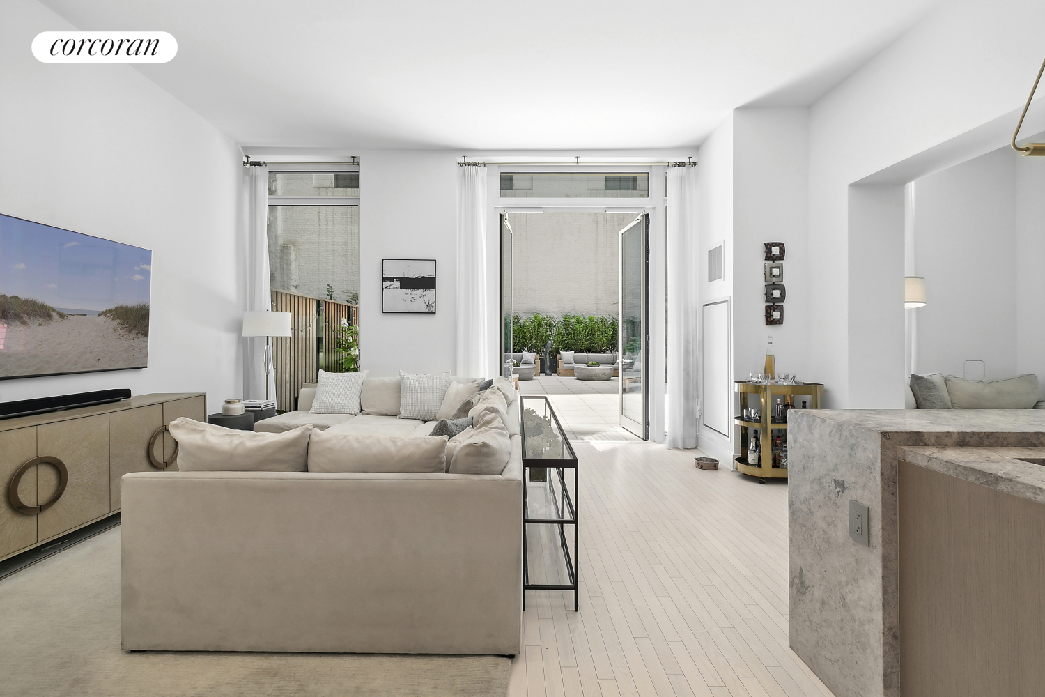 91 Leonard Street, Unit 2E Manhattan, NY 10013 - Photo 3 of 10 a living room with furniture and a flat screen tv