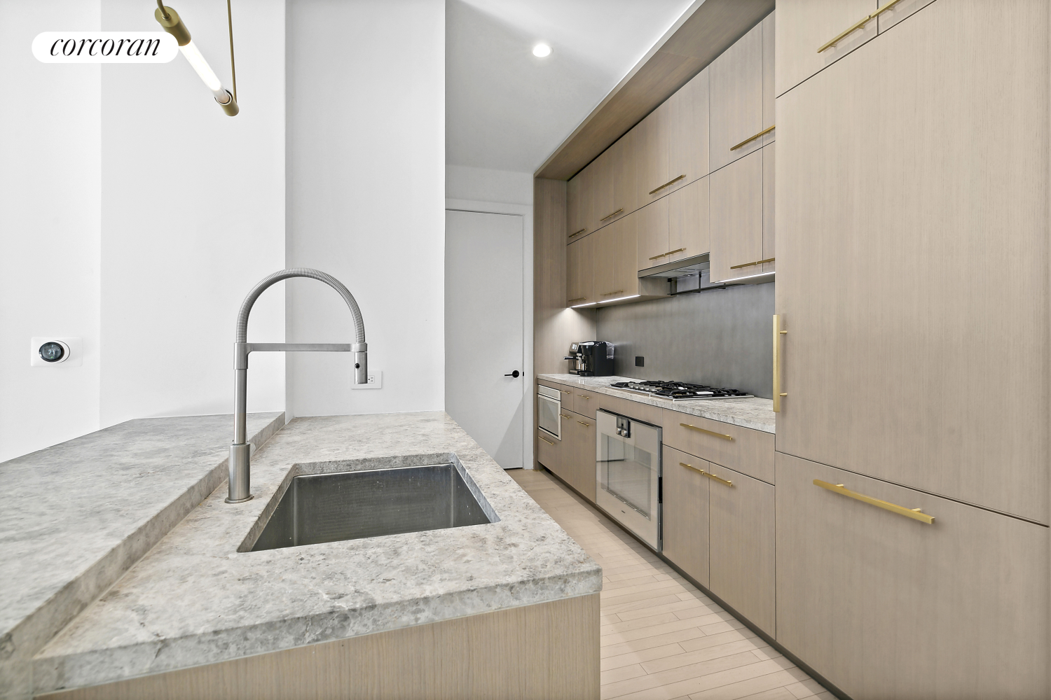 91 Leonard Street, Unit 2E Manhattan, NY 10013 - Photo 4 of 10 a kitchen with granite countertop a sink stainless steel appliances and cabinets