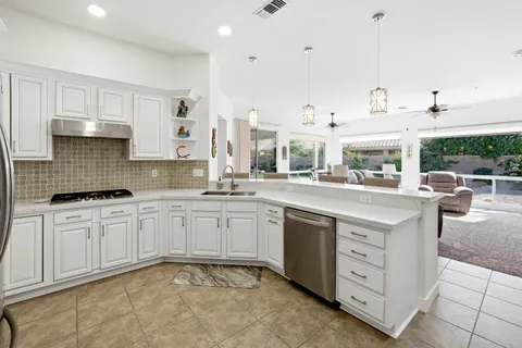 a kitchen with stainless steel appliances granite countertop a sink and cabinets