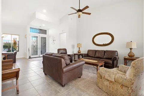 a living room with furniture a couch and a large window