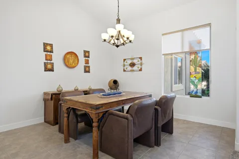 a view of a dining room with a table and chairs