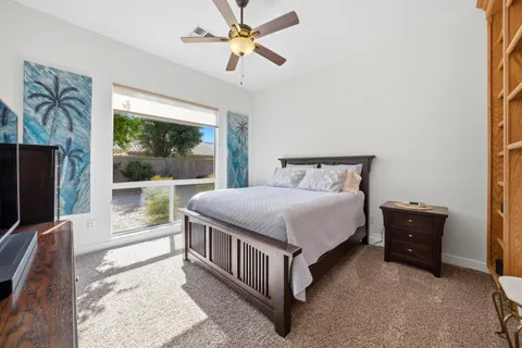 a spacious bedroom with a bed and a large window