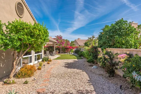 a view of a house with backyard and sitting area