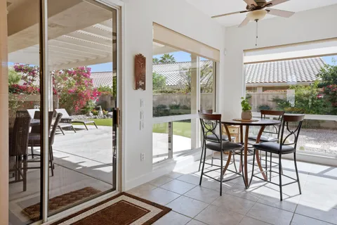 a view of a dining room with a table and chairs