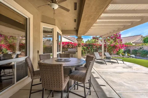 a view of a dining room with furniture and a potted plant