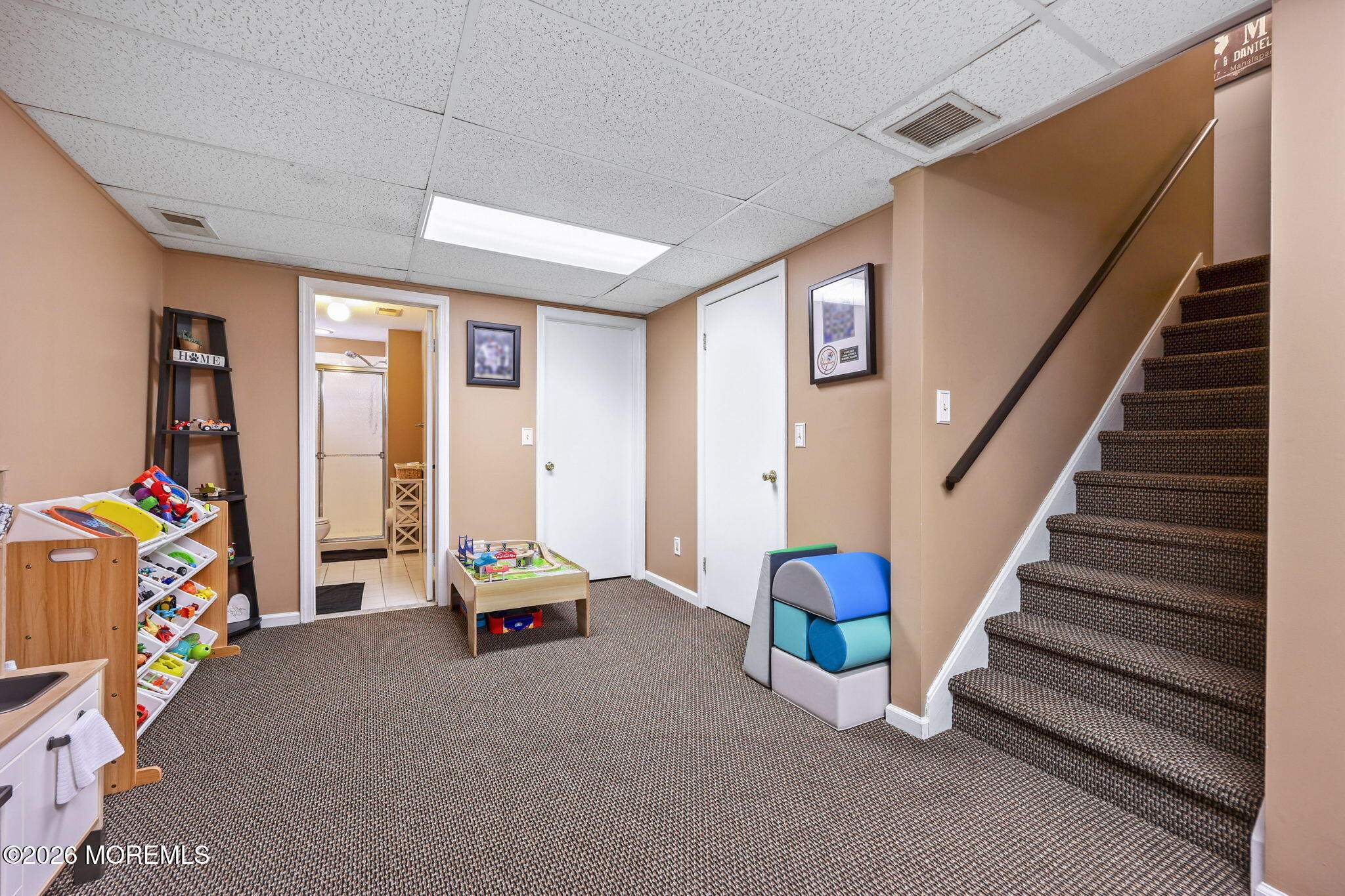 31 Atrium Way, Unit 31 Manalapan, NJ 07726 - Photo 21 of 34 a living room with furniture and stairs