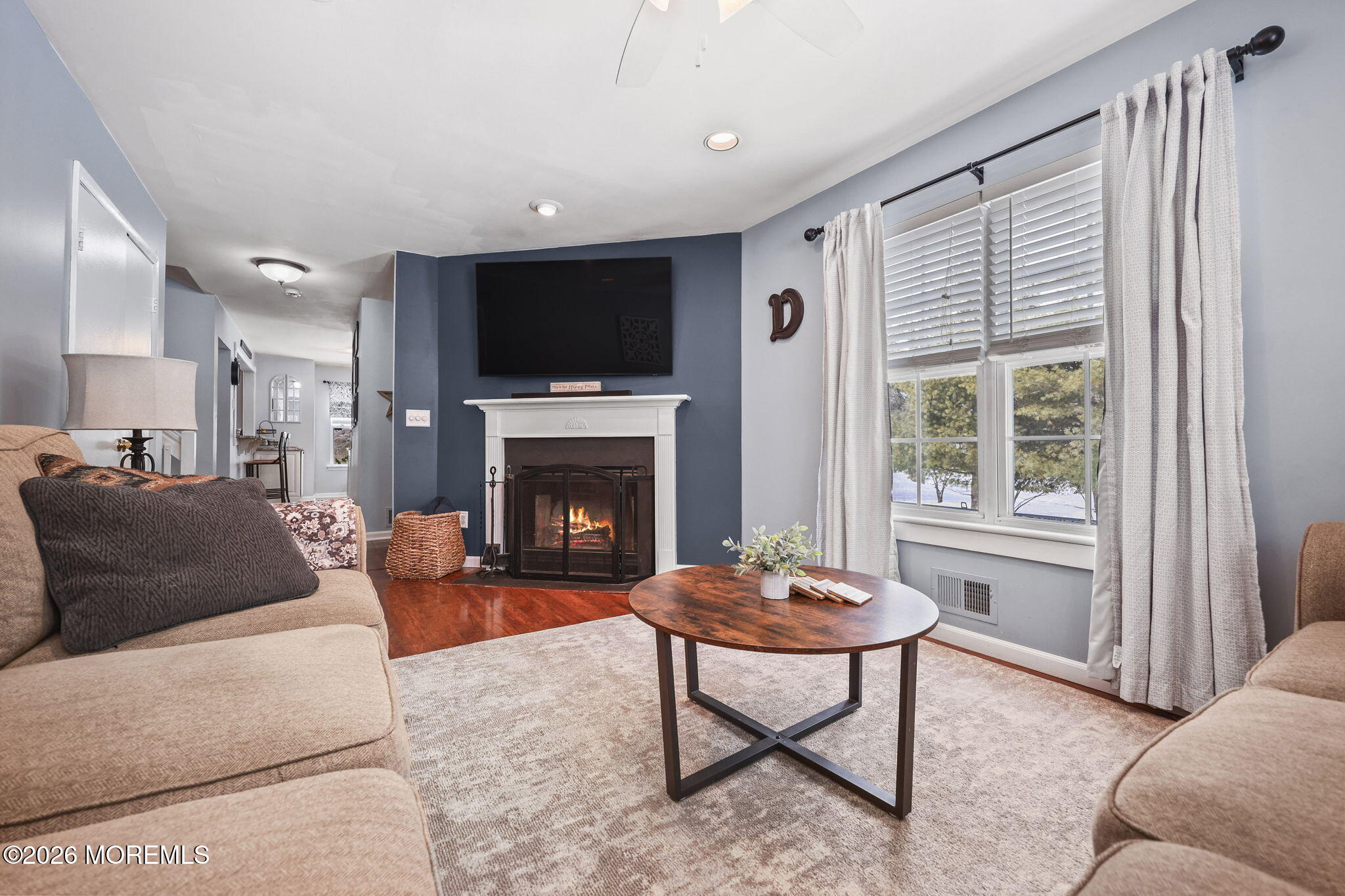 31 Atrium Way, Unit 31 Manalapan, NJ 07726 - Photo 6 of 34 a living room with furniture a flat screen tv and a fireplace