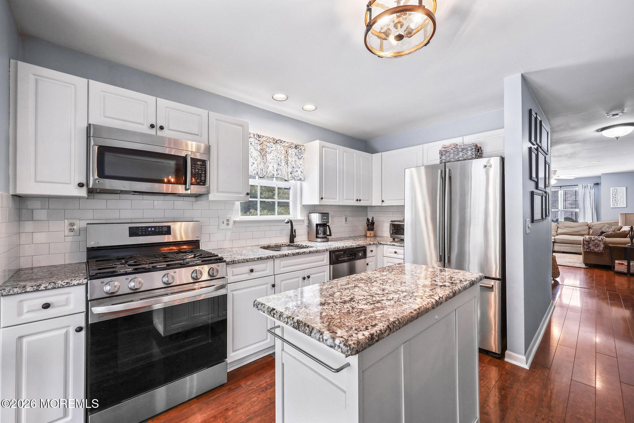 31 Atrium Way, Unit 31 Manalapan, NJ 07726 - Photo 10 of 34 a kitchen with a stove a microwave and refrigerator