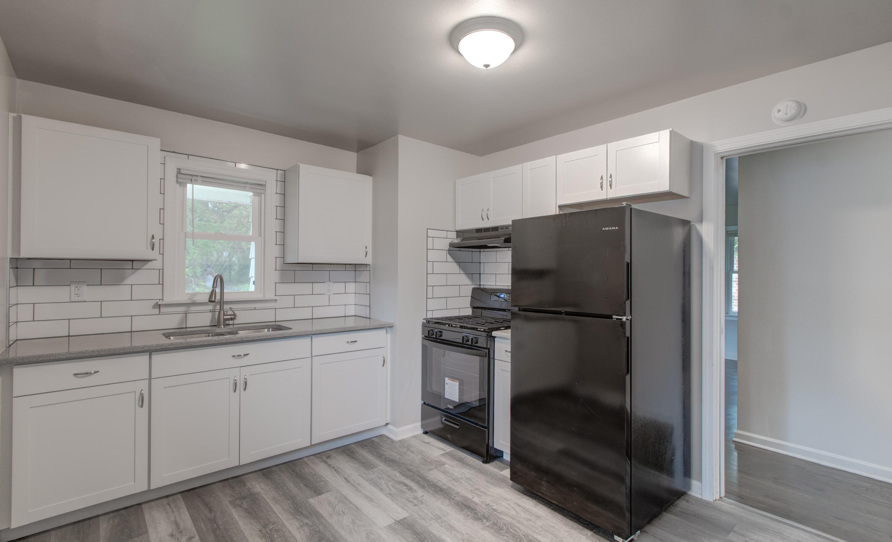 4727 Harrison Street Gary, IN 46408 - Photo 3 of 15 a kitchen with a refrigerator and a sink