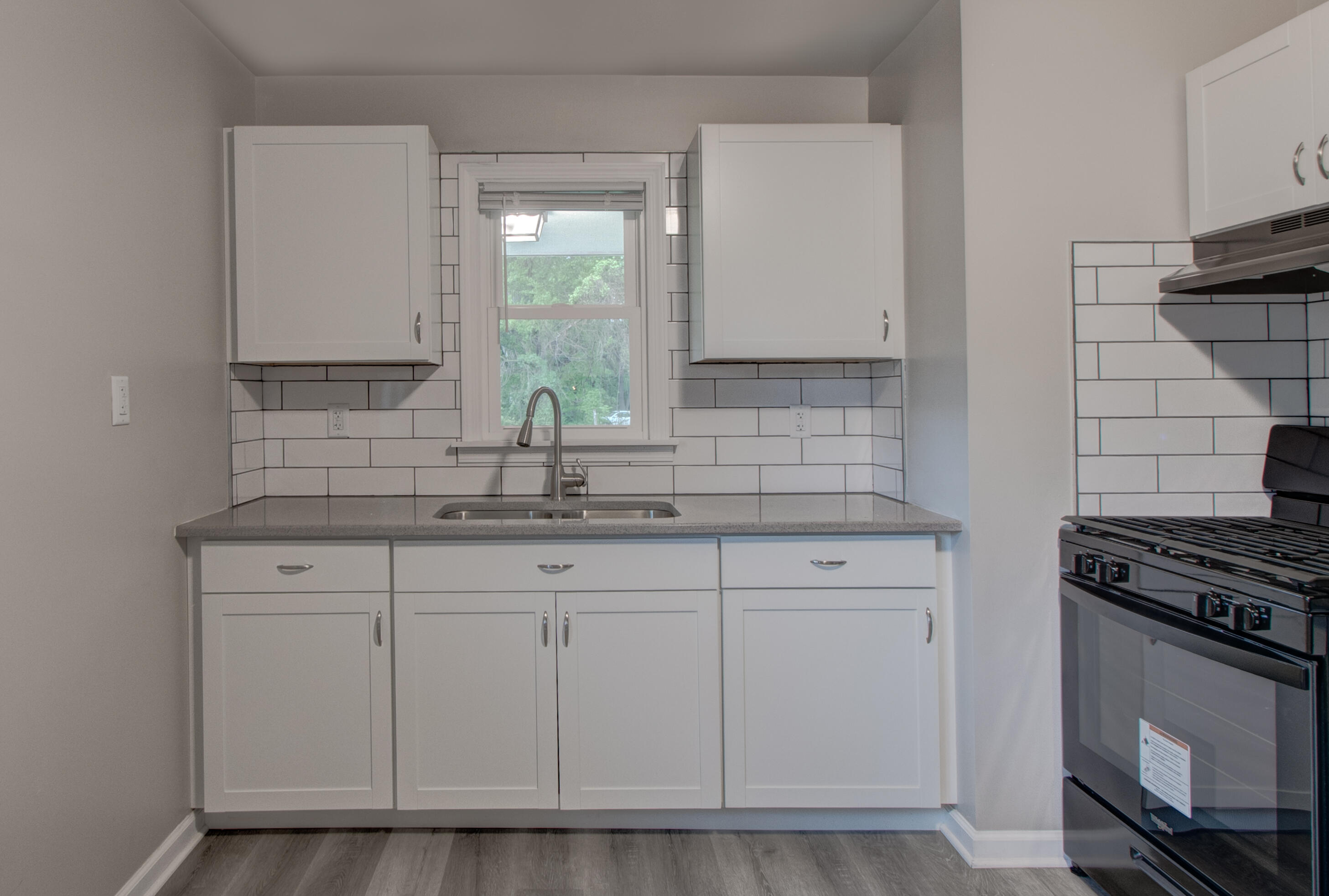 4727 Harrison Street Gary, IN 46408 - Photo 4 of 15 a kitchen with granite countertop white cabinets and a stove
