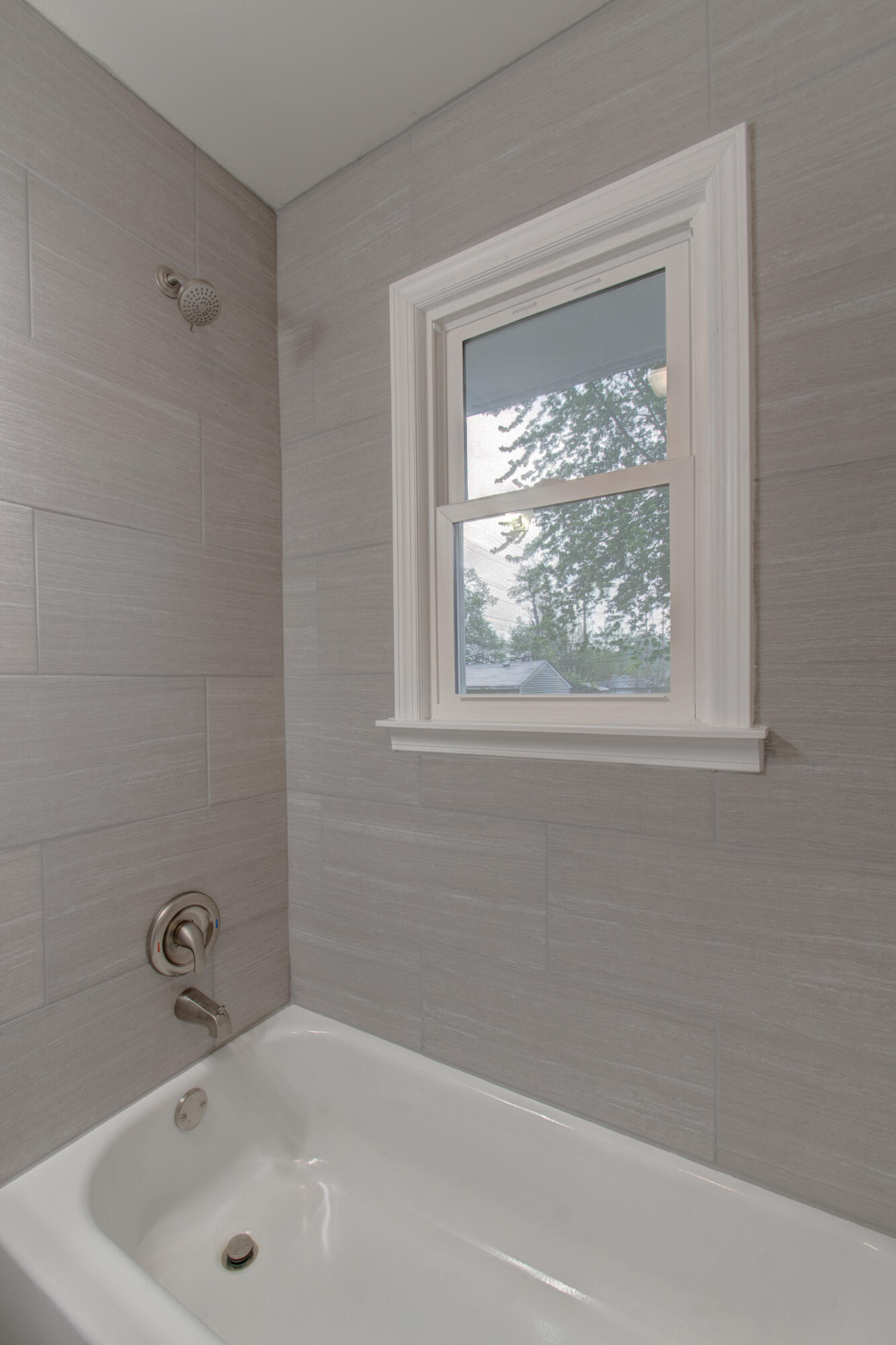 4727 Harrison Street Gary, IN 46408 - Photo 7 of 15 a bathroom with a tub a window and a shower