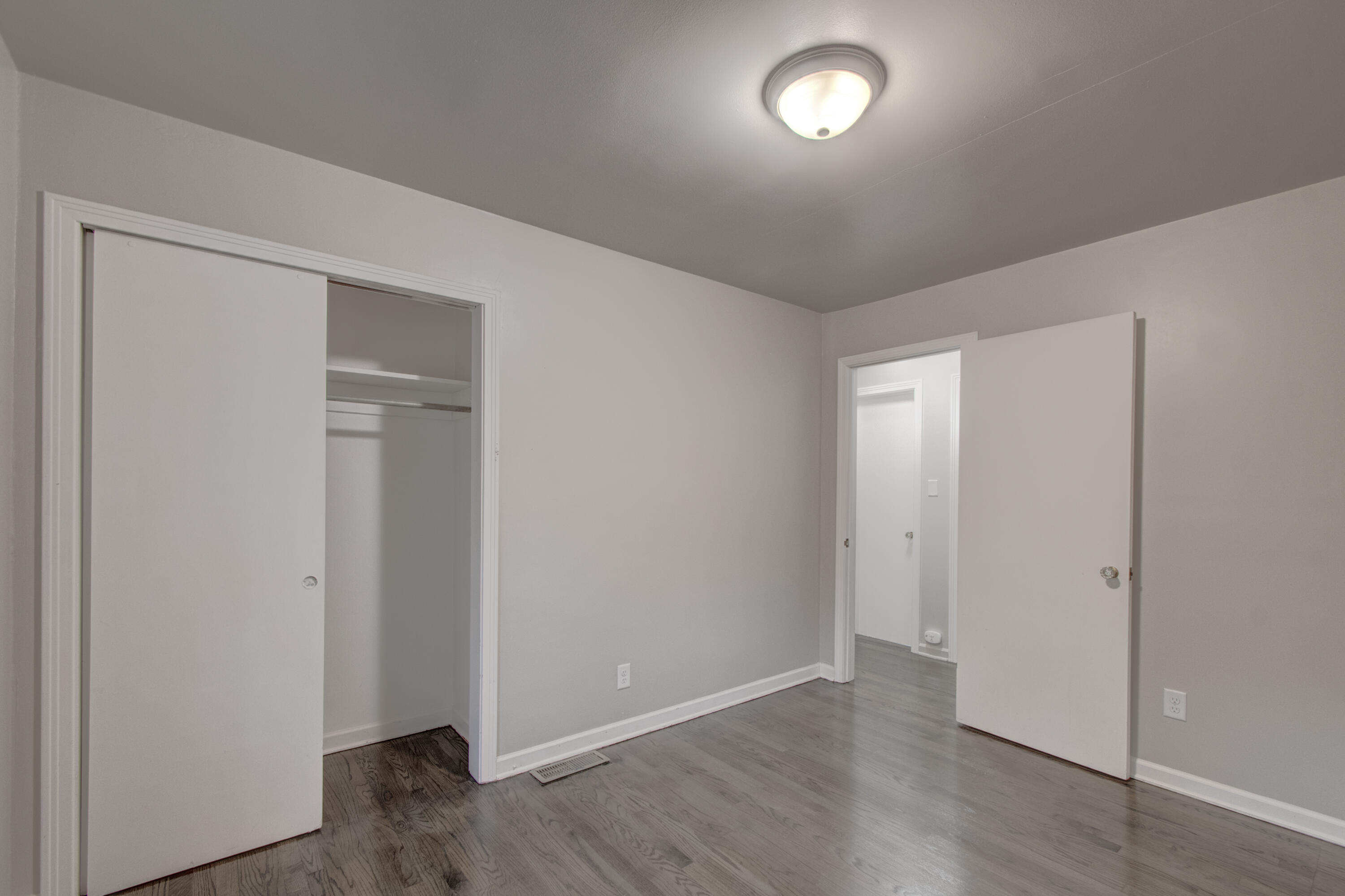 4727 Harrison Street Gary, IN 46408 - Photo 10 of 15 an empty room with wooden floor and windows