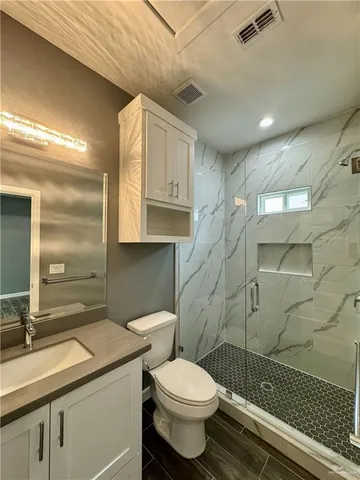 a bathroom with a sink toilet and shower
