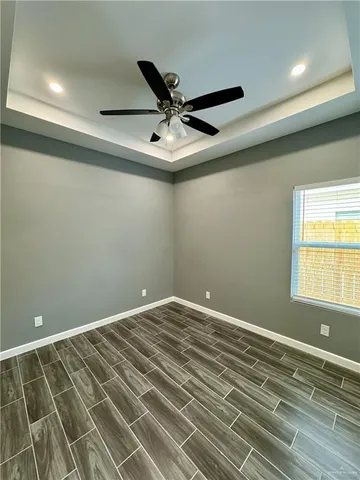 a view of a livingroom with a ceiling fan and window