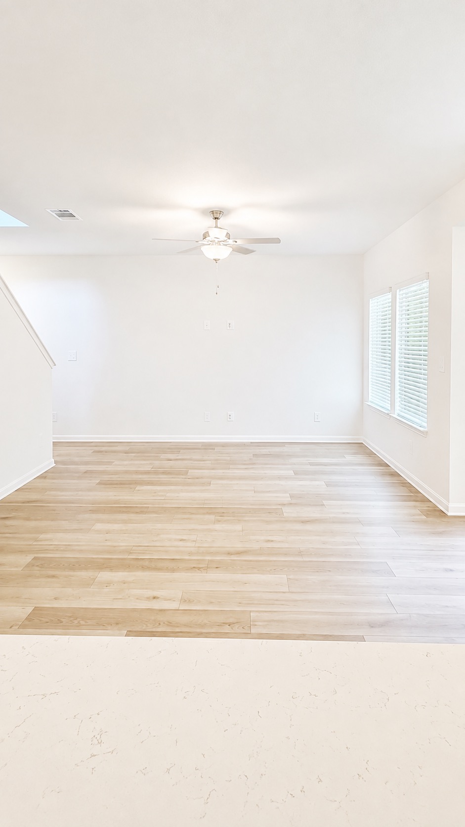 116 Maple Hedge Road Hutto, TX 78634 - Photo 8 of 13 Luminous living space offers light-toned wood flooring and a contemporary ceiling fan.