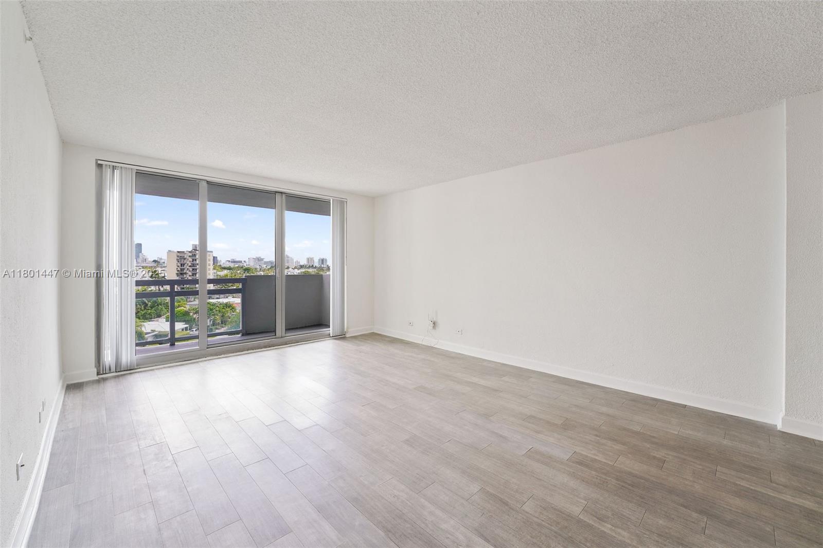 1500 Bay Road, Unit S0380 Miami Beach, FL 33139 - Photo 14 of 83 wooden floor in an empty room with a window