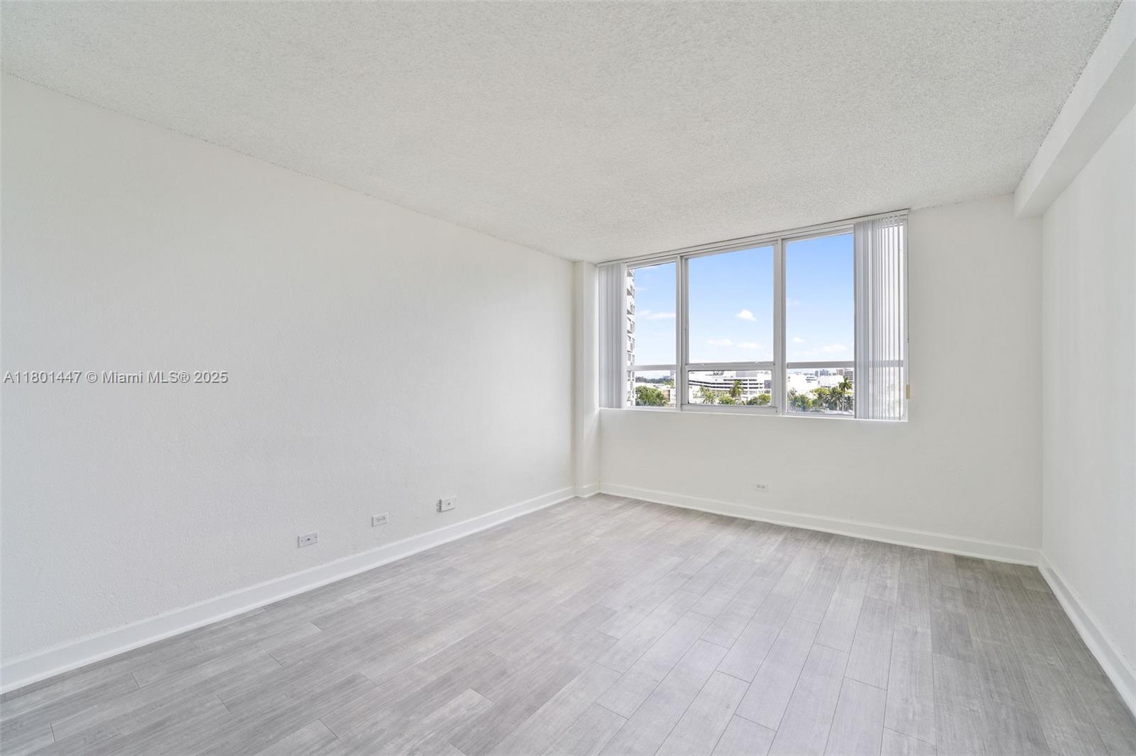 1500 Bay Road, Unit S0380 Miami Beach, FL 33139 - Photo 20 of 83 a view of an empty room with wooden floor and a window