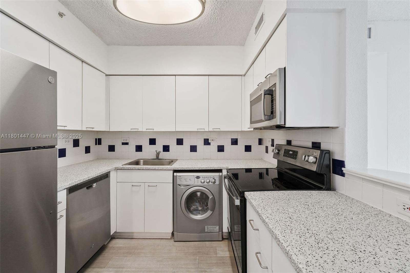 1500 Bay Road, Unit S0380 Miami Beach, FL 33139 - Photo 5 of 83 a utility room with cabinets washer and dryer