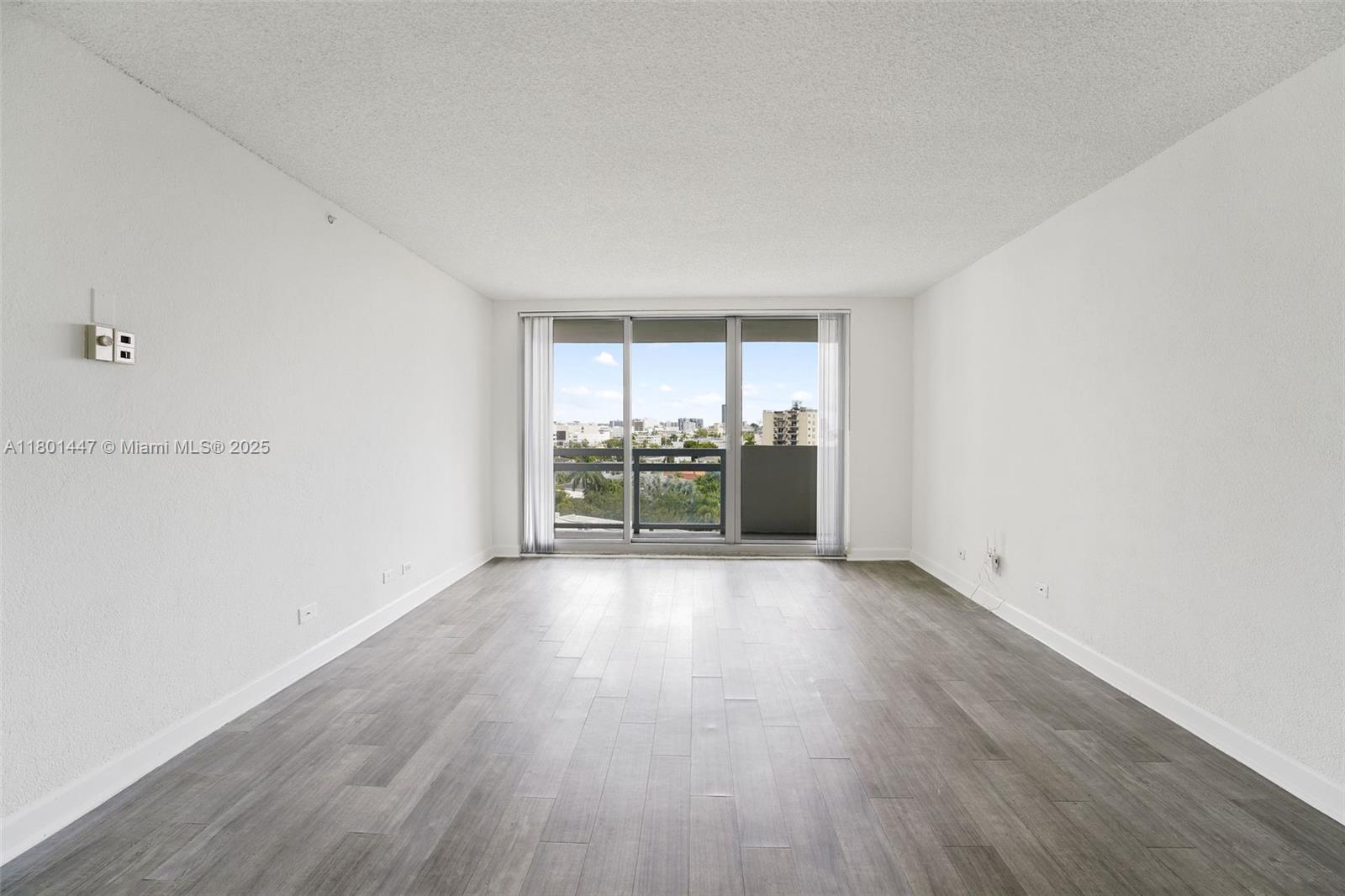 1500 Bay Road, Unit S0380 Miami Beach, FL 33139 - Photo 10 of 83 an empty room with wooden floor and furniture