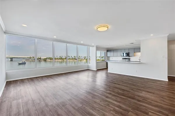 a large white kitchen with stainless steel appliances