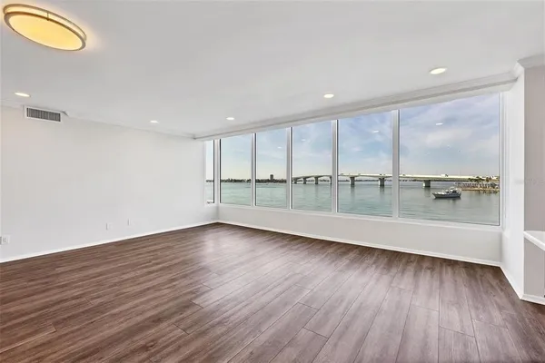 a view of a room with wooden floor and window