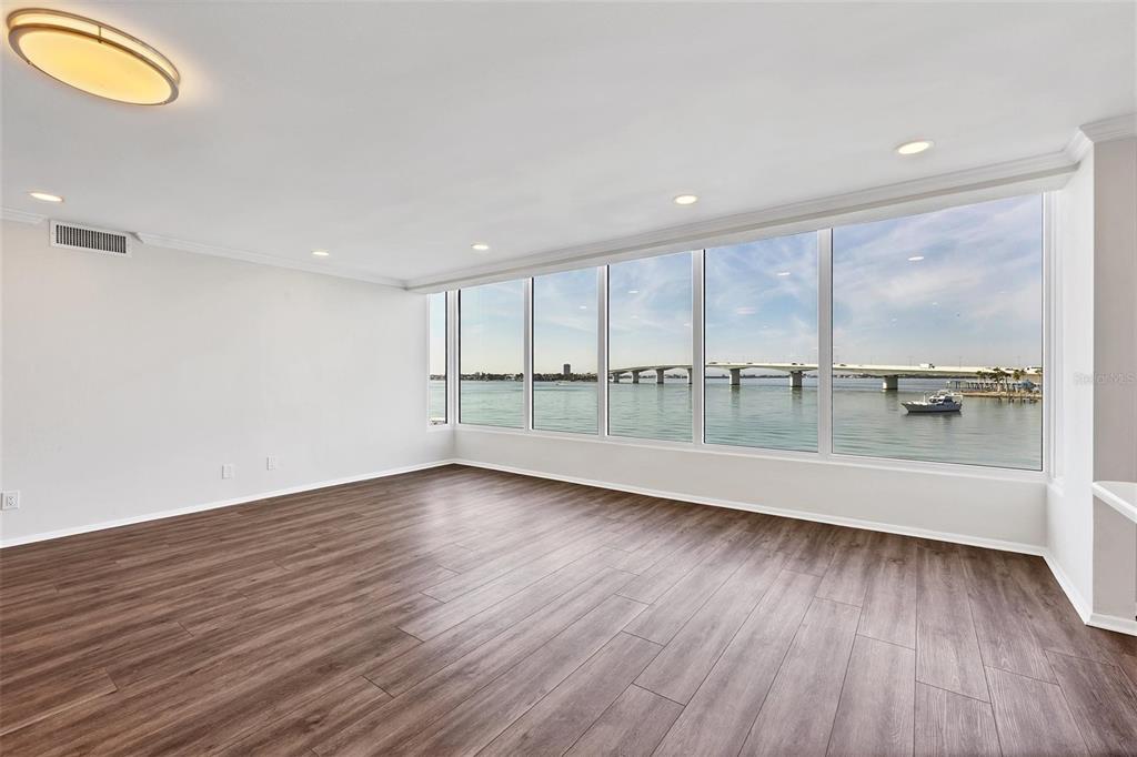 226 Golden Gate Point, Unit 32 Sarasota, FL 34236 - Photo 17 of 60 a view of an empty room with wooden floor and a window