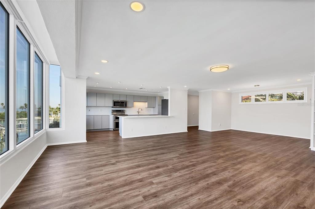 226 Golden Gate Point, Unit 32 Sarasota, FL 34236 - Photo 20 of 60 a view of empty room with wooden floor and kitchen view