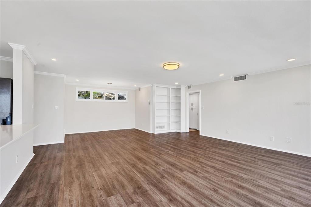 226 Golden Gate Point, Unit 32 Sarasota, FL 34236 - Photo 24 of 60 a view of an empty room with wooden floor and a window