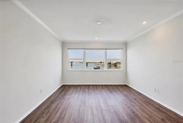 a view of a room with wooden floor and window