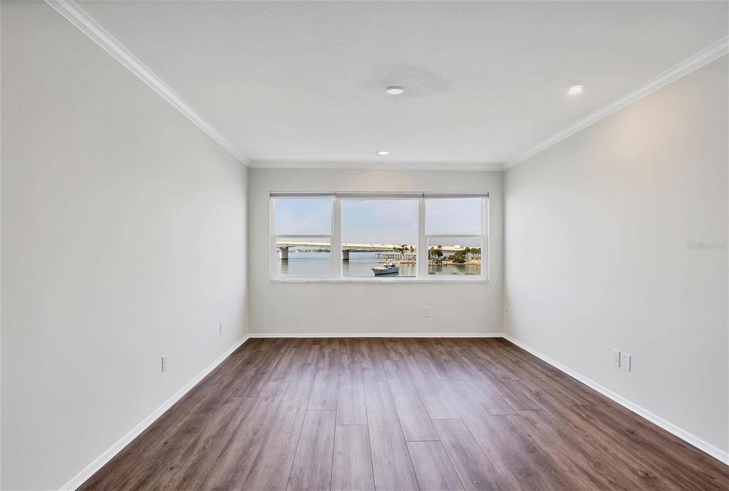 226 Golden Gate Point, Unit 32 Sarasota, FL 34236 - Photo 25 of 60 a view of a room with wooden floor and window
