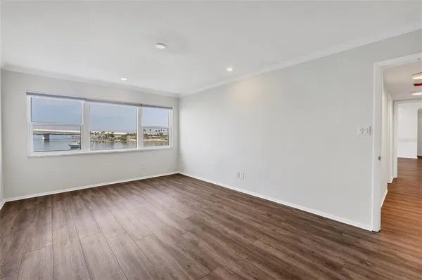 a view of an empty room with wooden floor