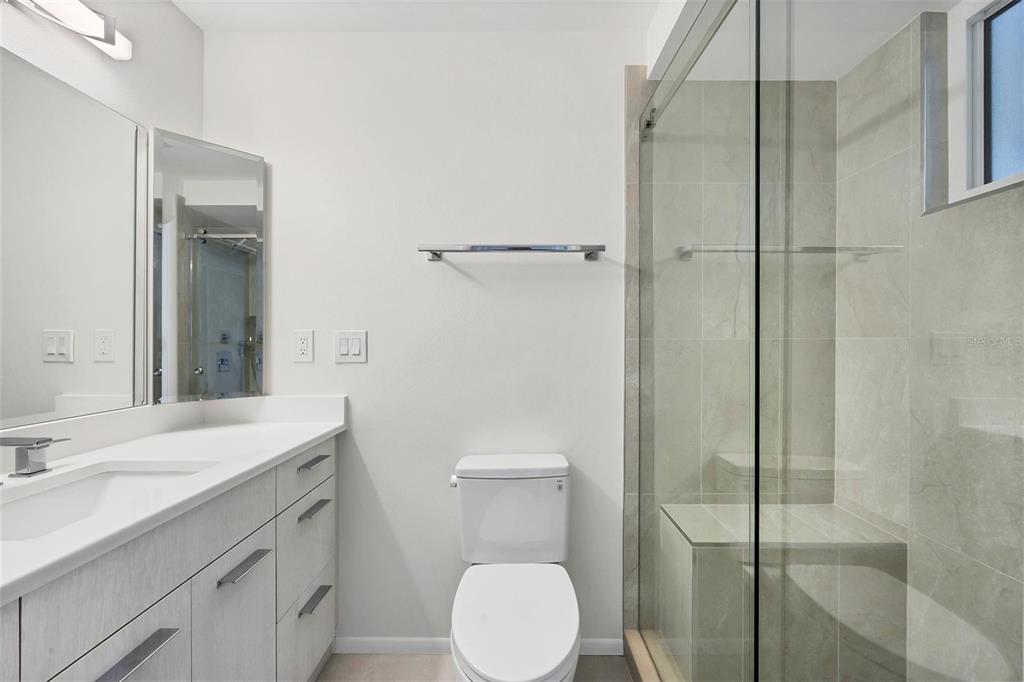 226 Golden Gate Point, Unit 32 Sarasota, FL 34236 - Photo 30 of 60 a bathroom with a sink toilet and shower