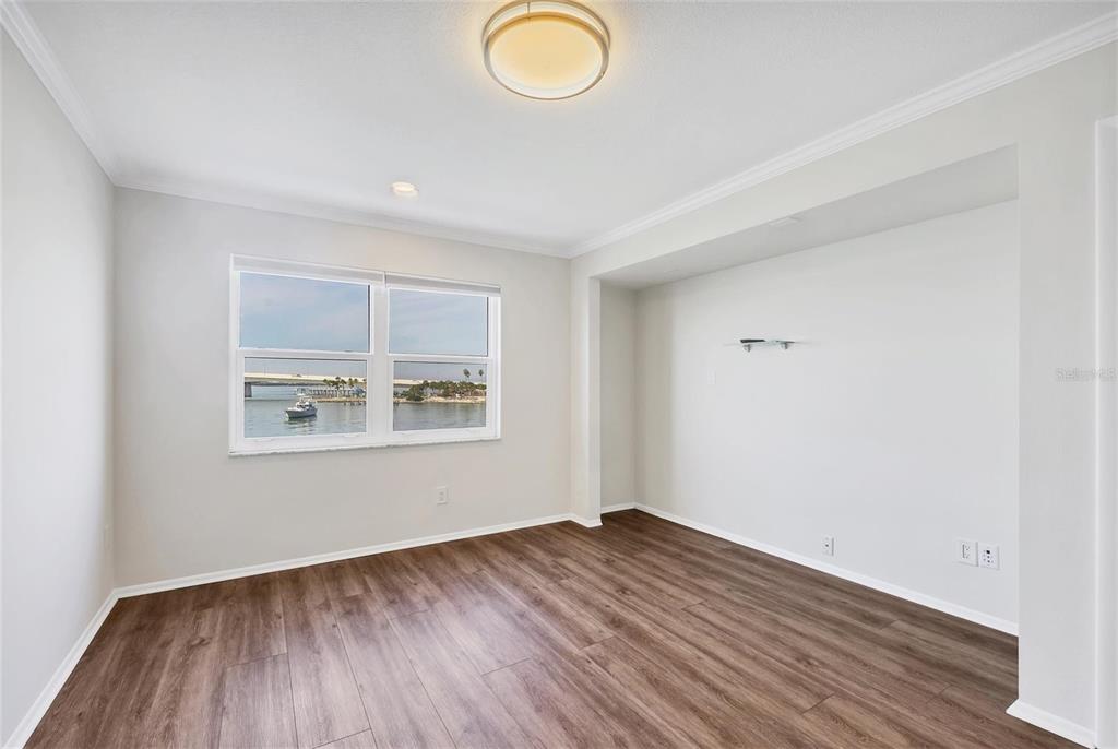 226 Golden Gate Point, Unit 32 Sarasota, FL 34236 - Photo 33 of 60 an empty room with wooden floor and windows