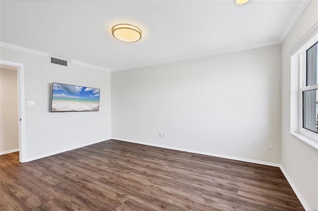 226 Golden Gate Point, Unit 32 Sarasota, FL 34236 - Photo 34 of 60 a view of a room with wooden floor and window