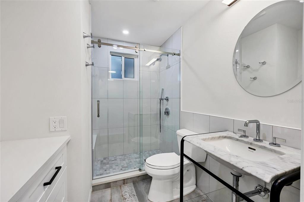 226 Golden Gate Point, Unit 32 Sarasota, FL 34236 - Photo 37 of 60 a bathroom with a sink toilet and shower