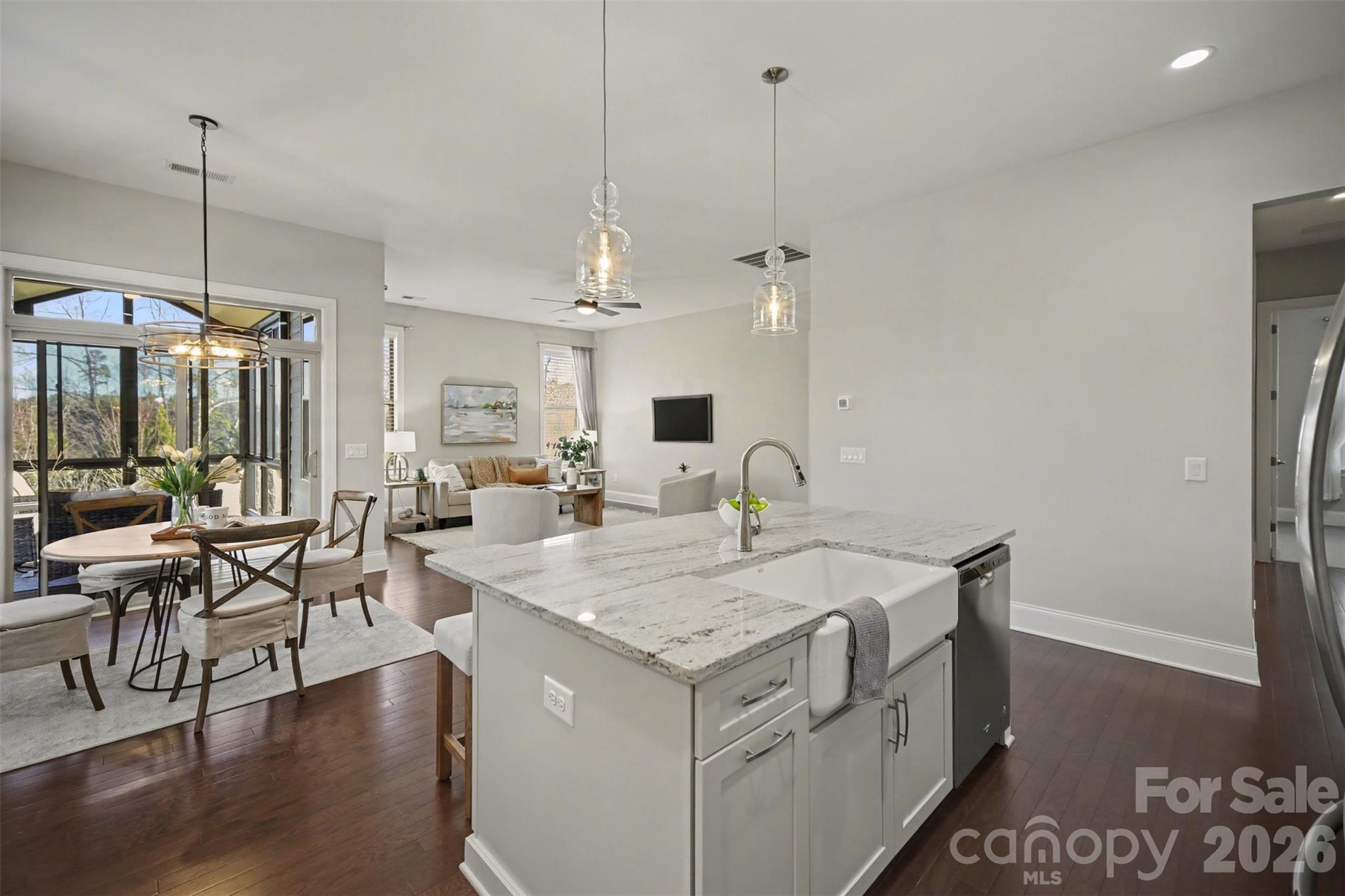 15828 Vale Ridge Drive Charlotte, NC 28278 - Photo 11 of 33 a view of kitchen island with stainless steel appliances wooden floor dining table and chairs