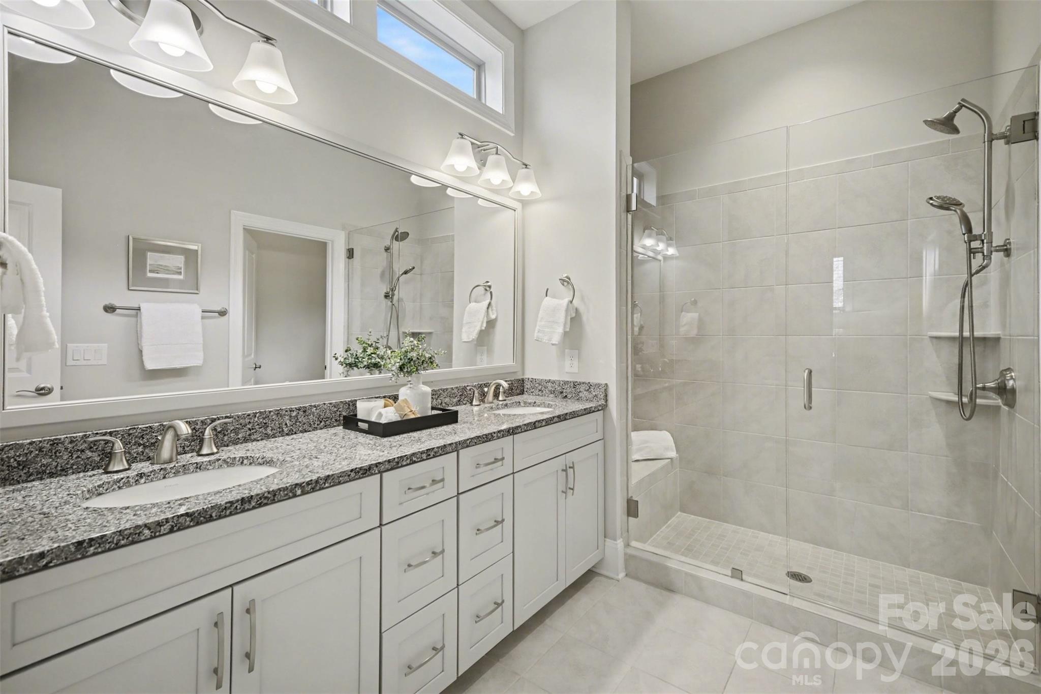 15828 Vale Ridge Drive Charlotte, NC 28278 - Photo 21 of 33 a bathroom with a double vanity sink mirror double and shower