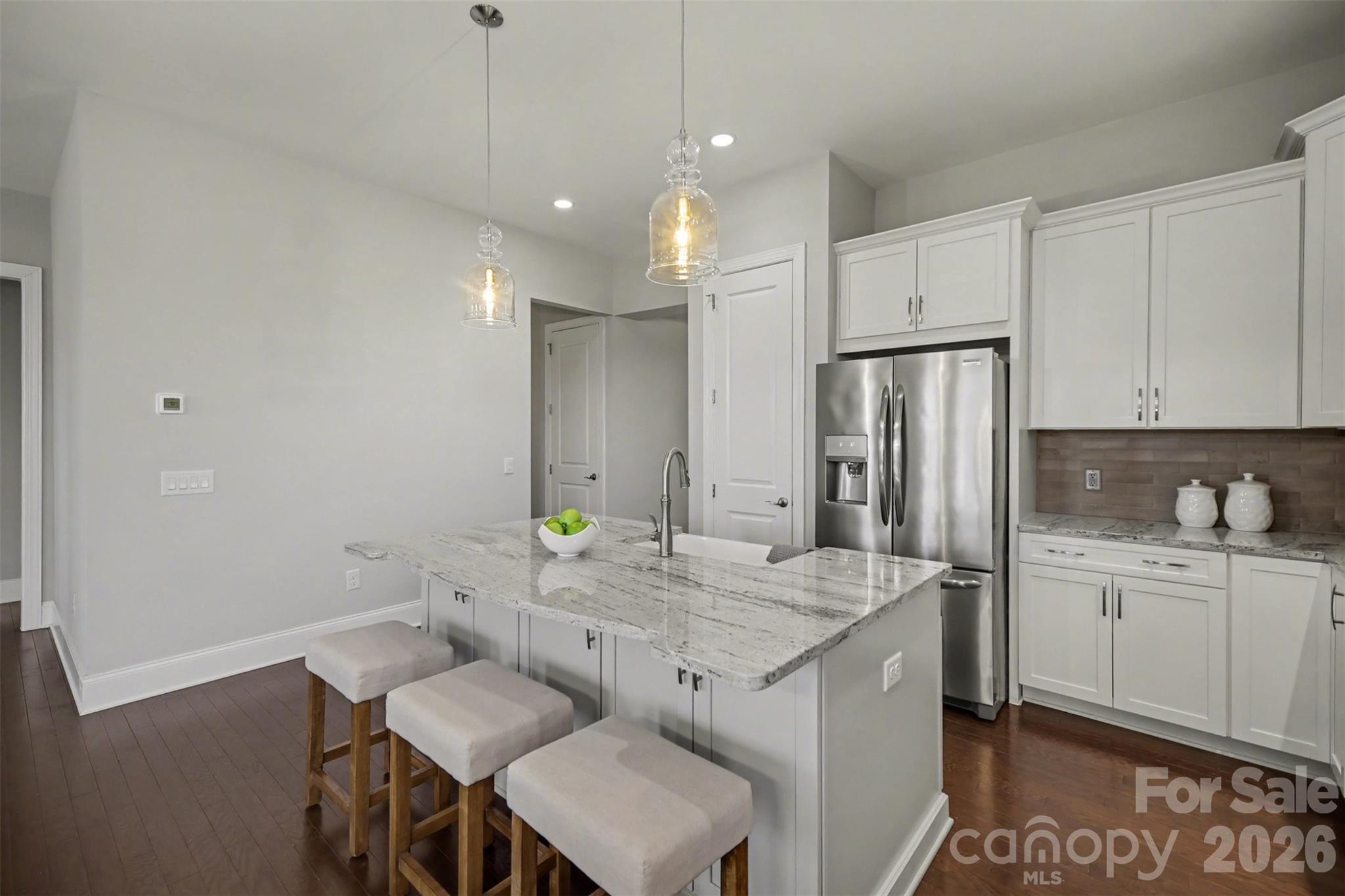 15828 Vale Ridge Drive Charlotte, NC 28278 - Photo 10 of 33 a kitchen with a sink refrigerator and cabinets